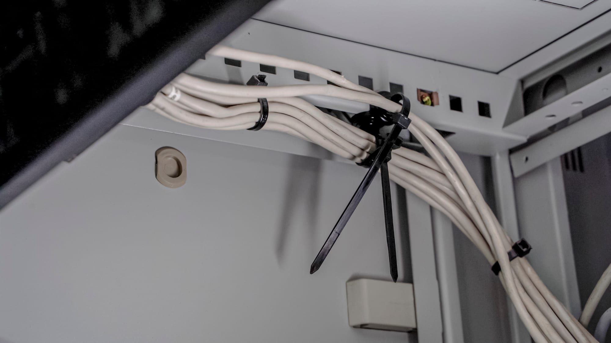 Network cables bundled to a magnetic mount inside a server rack